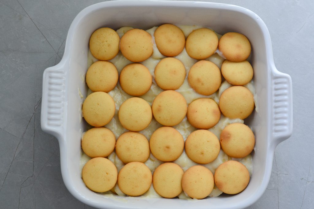 baking dish with layers of vanilla wafers, banana slices, and pudding