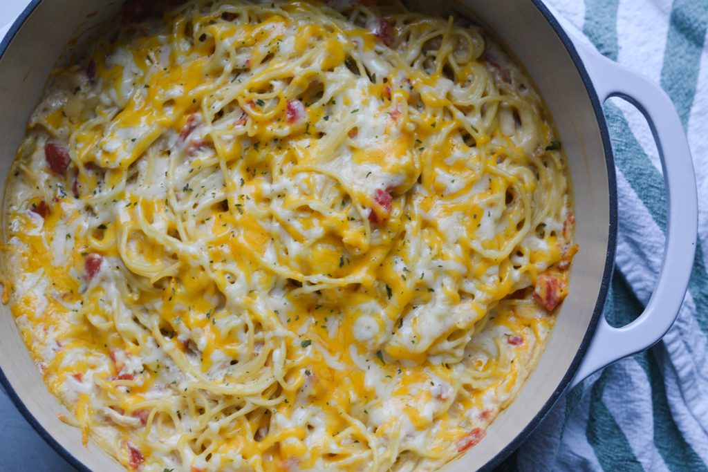 chicken spaghetti with rotel topped with cheese after baking