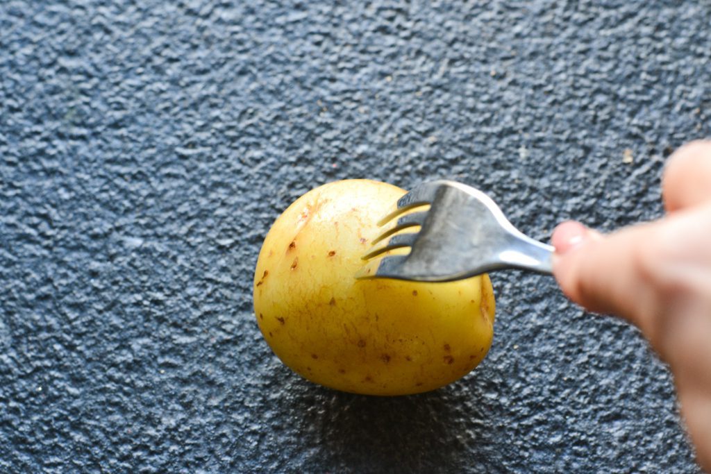 pierce potatoes with a fork