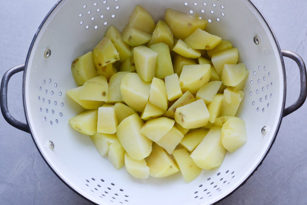 boiled potatoes in a strainer