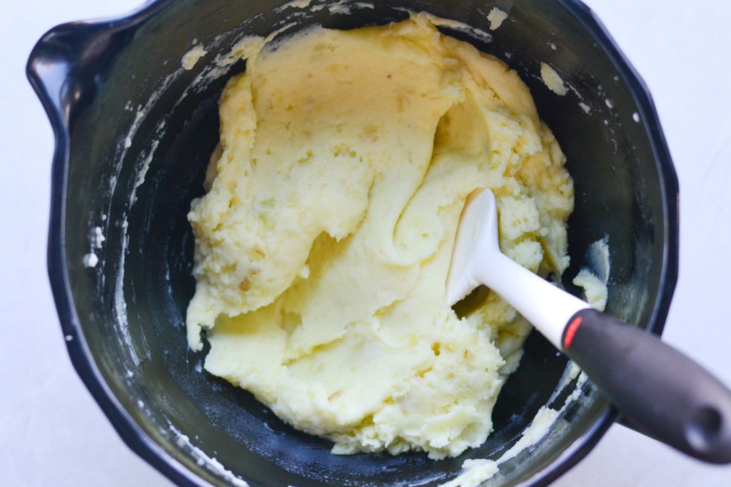 smooth and creamy mashed potatoes in a mixing bowl