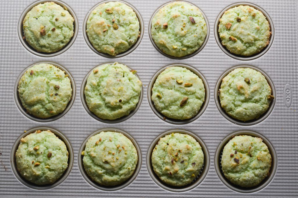 pistachio muffins in a muffin tin